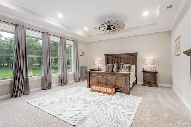 carpeted bedroom featuring multiple windows, crown molding, and a raised ceiling