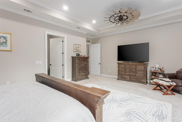 bedroom with ornamental molding, light carpet, and a raised ceiling