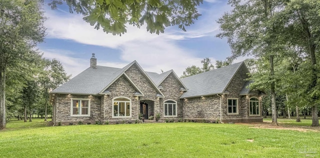 9180 Chumuckla Hwy, Pace, FL 32571 - french provincial home with a chimney, a front lawn, roof with shingles, and stone siding