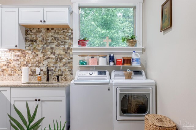 9180 Chumuckla Hwy, Pace, FL 32571 - clothes washing area with cabinet space, washer and clothes dryer, and a sink