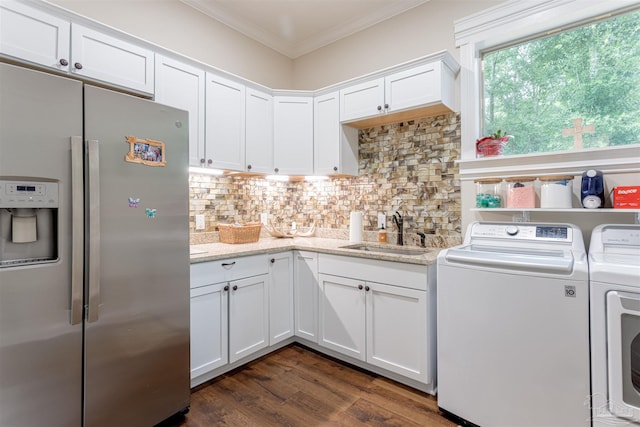 kitchen featuring decorative backsplash, sink, washer and dryer, stainless steel fridge, and dark wood-type flooring