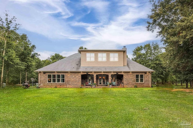 9180 Chumuckla Hwy, Pace, FL 32571 - back of house with a chimney, a yard, a shingled roof, and covered porch