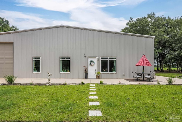 view of front of home with a front lawn and a patio area