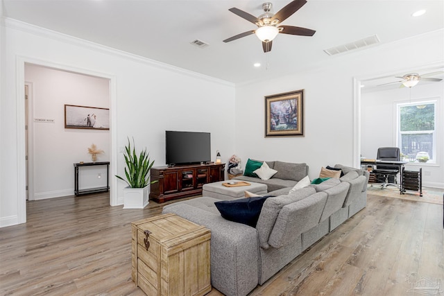 living room featuring ceiling fan, light hardwood / wood-style flooring, and ornamental molding