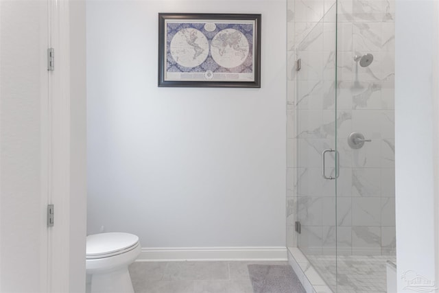 bathroom featuring a shower with shower door, tile patterned flooring, and toilet