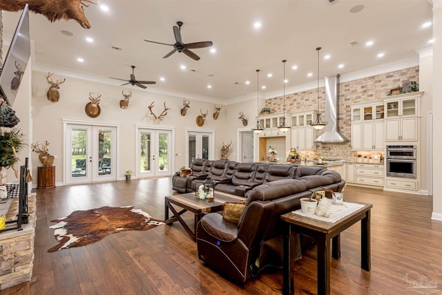 living room with ornamental molding, french doors, hardwood / wood-style floors, and ceiling fan