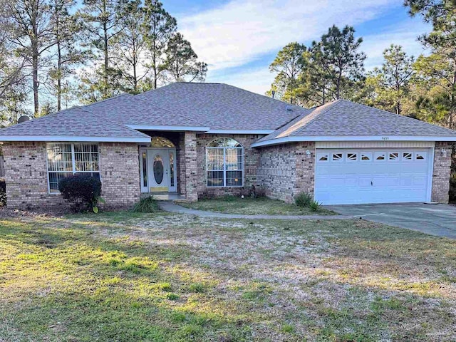 ranch-style home featuring a garage and a front yard