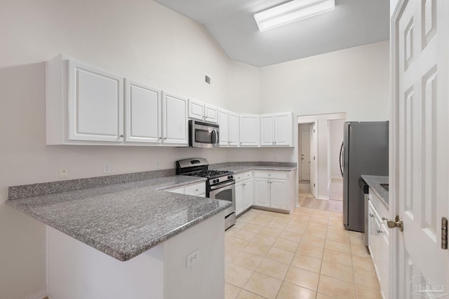 kitchen featuring kitchen peninsula, appliances with stainless steel finishes, high vaulted ceiling, and white cabinetry