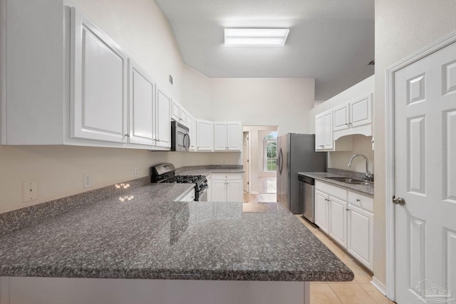 kitchen with kitchen peninsula, stainless steel appliances, white cabinetry, and sink