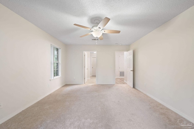 carpeted empty room featuring a textured ceiling and ceiling fan