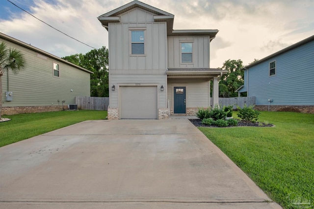 2275 Janet St, Navarre, FL 32566 - view of front of home featuring board and batten siding, brick siding, a garage, and concrete driveway