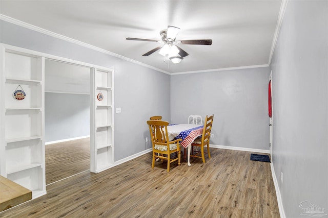6790 Data St, Pensacola, FL 32504 - dining room with ceiling fan, wood finished floors, crown molding, and built in shelves