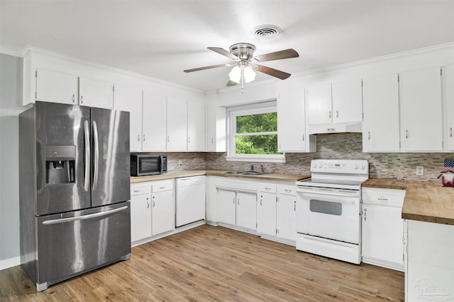 6790 Data St, Pensacola, FL 32504 - kitchen with appliances with stainless steel finishes, decorative backsplash, light wood-style floors, white cabinets, and crown molding