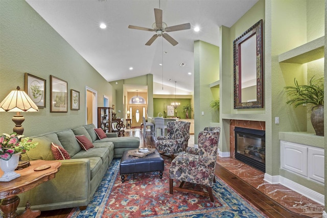 living area with vaulted ceiling, recessed lighting, a fireplace, wood finished floors, and a ceiling fan