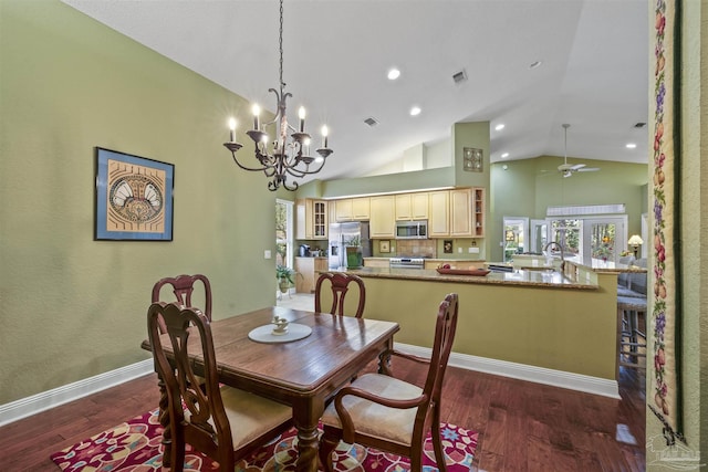 dining area featuring dark wood finished floors, ceiling fan with notable chandelier, visible vents, and baseboards