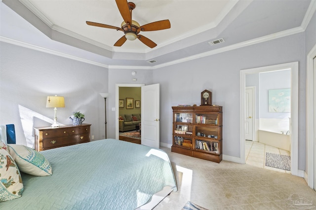 bedroom with a tray ceiling, visible vents, carpet flooring, and crown molding