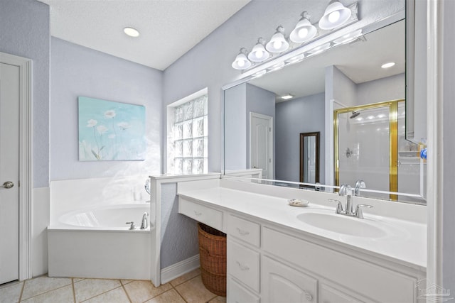 bathroom with vanity, a garden tub, a stall shower, tile patterned floors, and a textured ceiling