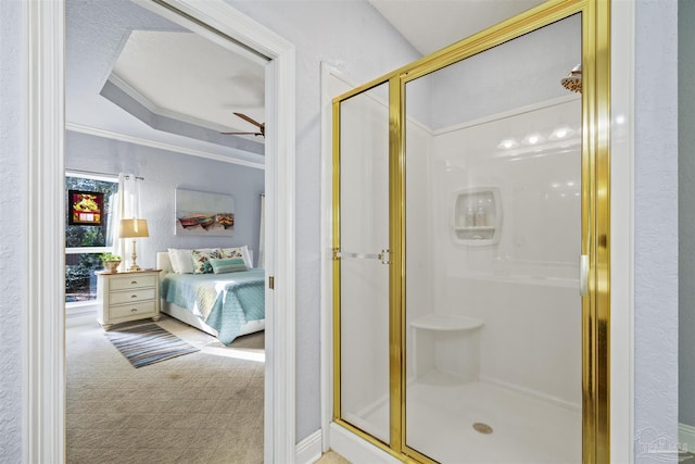 ensuite bathroom featuring a shower stall, connected bathroom, ceiling fan, ornamental molding, and a textured wall