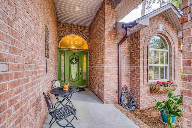 property entrance featuring brick siding