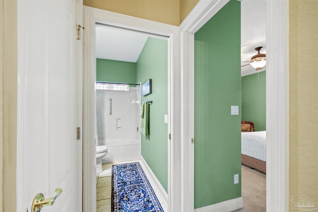 hallway with tile patterned floors and baseboards