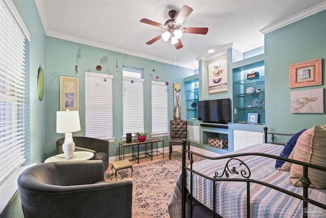 living room with built in shelves, baseboards, ceiling fan, and ornamental molding