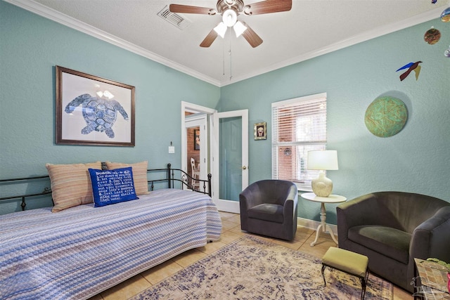 bedroom with visible vents, crown molding, ceiling fan, a textured wall, and tile patterned floors