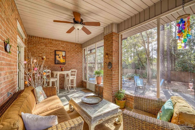 sunroom featuring ceiling fan