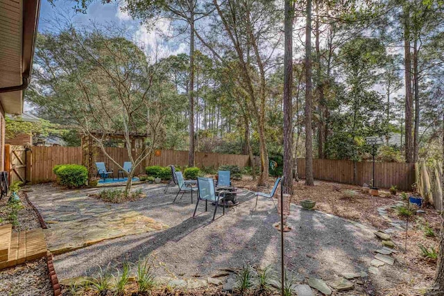 view of patio / terrace featuring a fenced backyard and an outdoor fire pit