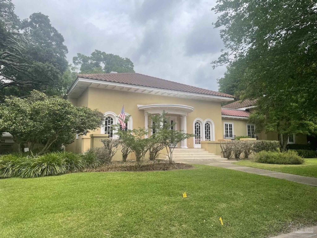 1904 E Larua St, Pensacola, FL 32501 - view of front of property featuring a tile roof, a front lawn, and stucco siding