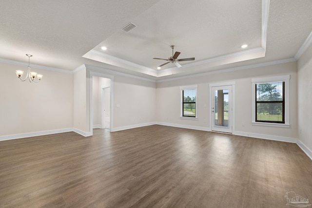 spare room with dark wood-type flooring, crown molding, and a tray ceiling