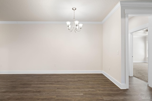 spare room featuring ornamental molding, ceiling fan with notable chandelier, and dark hardwood / wood-style flooring