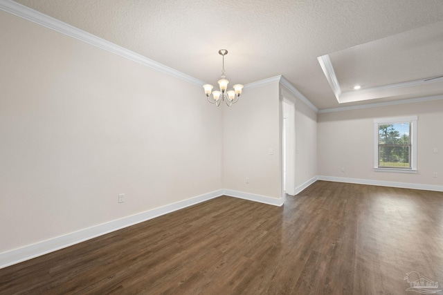 empty room featuring ornamental molding, a chandelier, a textured ceiling, and dark hardwood / wood-style flooring