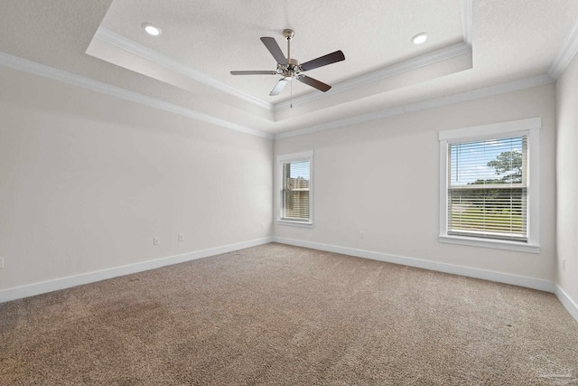 carpeted empty room with crown molding, a tray ceiling, a textured ceiling, and ceiling fan