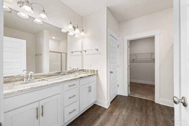 bathroom featuring vanity, hardwood / wood-style floors, and an enclosed shower