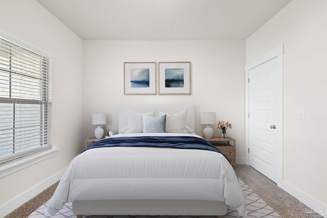 bedroom featuring light colored carpet