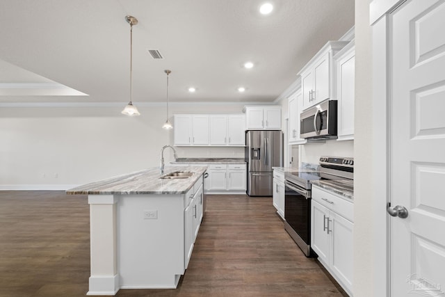 kitchen featuring appliances with stainless steel finishes, sink, decorative light fixtures, and white cabinets