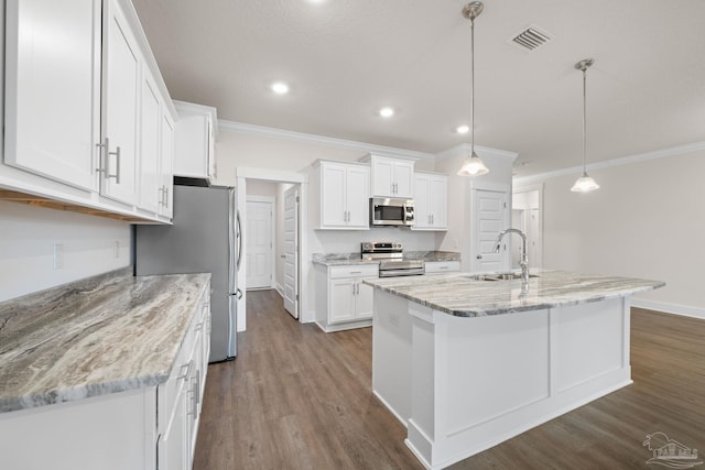 kitchen featuring white cabinetry, appliances with stainless steel finishes, sink, and pendant lighting