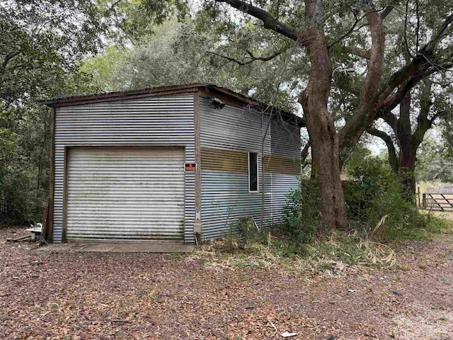 view of side of home with a garage and an outbuilding