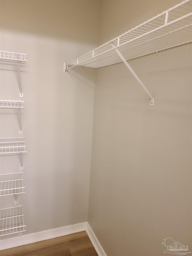 spacious closet with wood finished floors