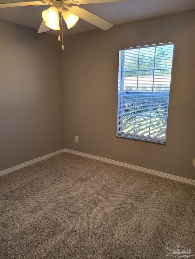 unfurnished room with baseboards, carpet, and ceiling fan