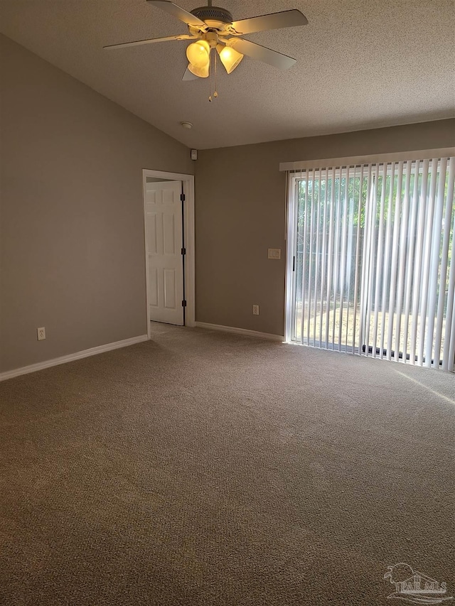 carpeted spare room with ceiling fan, baseboards, and a textured ceiling