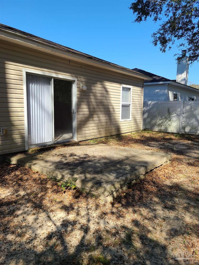 back of property with a patio and fence