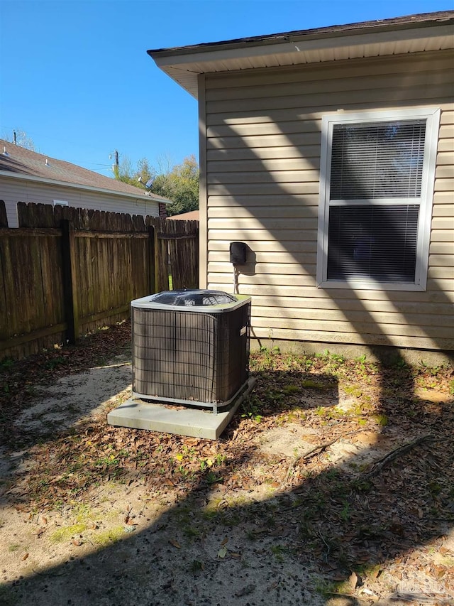 exterior space with central air condition unit and fence