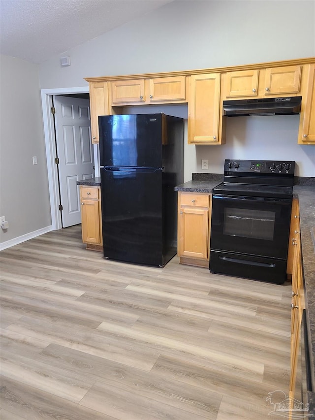 kitchen with black appliances, under cabinet range hood, dark countertops, light wood finished floors, and lofted ceiling