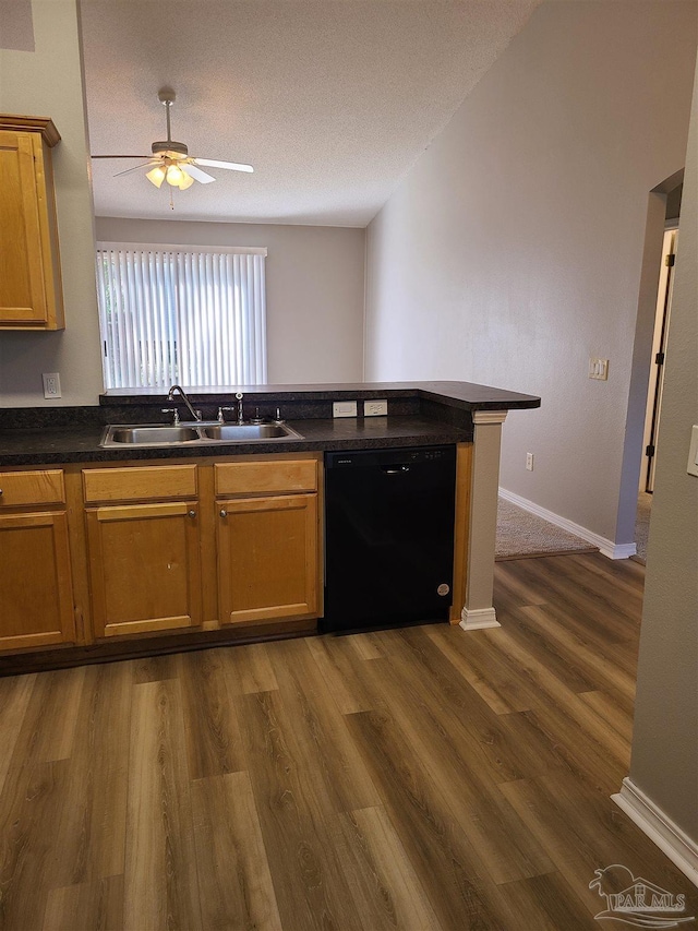 kitchen with dark countertops, black dishwasher, dark wood-style floors, and a sink