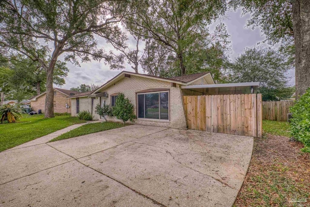 view of front of property featuring a garage and a front lawn