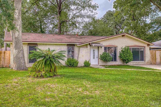 ranch-style home with a front lawn