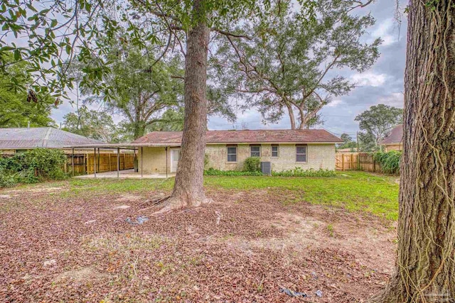 rear view of house with a yard