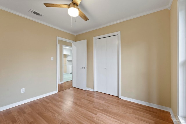 unfurnished bedroom featuring a closet, ceiling fan, crown molding, and light hardwood / wood-style floors