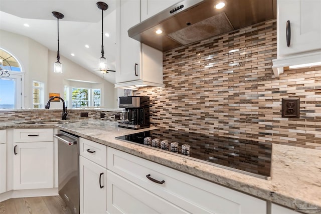5136 Point Shores Ln, Gulf Breeze, FL 32563 - kitchen with tasteful backsplash, a sink, white cabinets, black electric stovetop, and extractor fan
